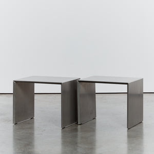 Pair of bent stainless steel tables