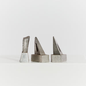 Trio of cast aluminium sculptures with bases