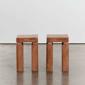 Pair of sculptural lime-washed side tables