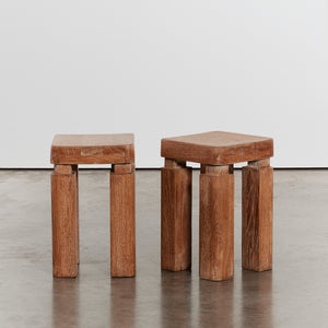 Pair of sculptural lime-washed side tables
