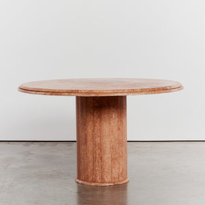 Round stone dining table with faceted base