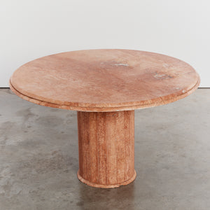 Round stone dining table with faceted base