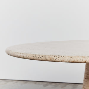 Round travertine dining table with conical base