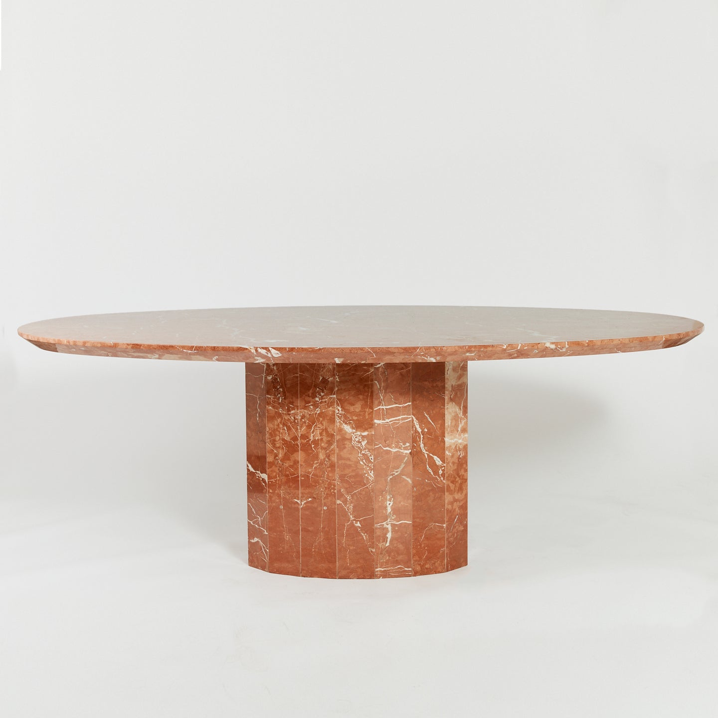 Rojo Coralito marble faceted dining table
