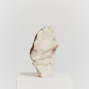 Carved abstract stone sculpture with raw edge