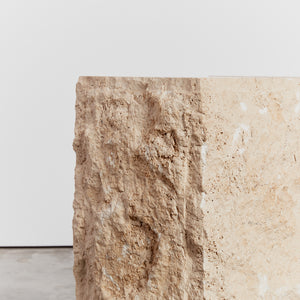 Sculptural raw edged console in travertine