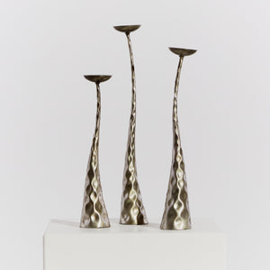 Trio of textured metal candlesticks