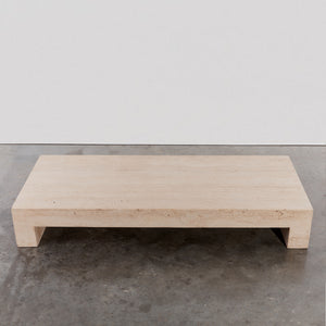 Low monolithic travertine coffee table