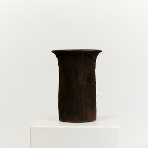 Tall linear textured brown pottery vase - HIRE ONLY